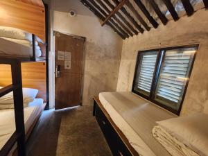 a room with two bunk beds and a window at Chinatown Hostel by Mingle in Kuala Lumpur