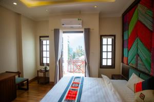 a bedroom with a bed and a large window at Le Boutique Sapa Hotel in Sa Pa