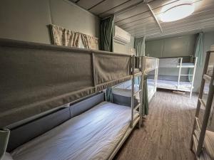 Postel nebo postele na pokoji v ubytování 鉄木彩虹小屋