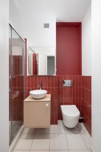 a bathroom with a toilet and a sink at ECRU Design Apartment in City Center WWA46 in Warsaw