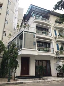 a white building with a balcony on the side of it at Cozy room close center 671 p41 in Hanoi