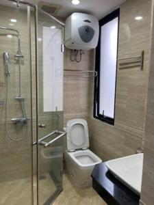 a bathroom with a shower and a toilet and a sink at Cozy room close center 671 p41 in Hanoi
