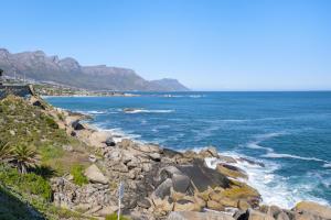 a view of the ocean from a rocky beach at Clifton Studio 104 in Cape Town