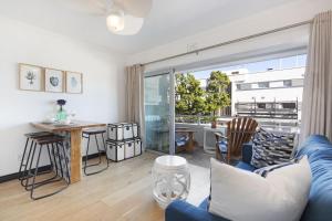 a living room with a blue couch and a table at Clifton Studio 104 in Cape Town