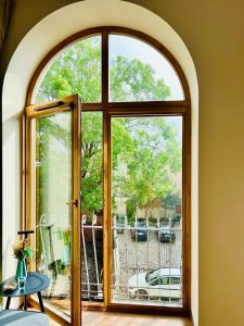 an arched glass door leading to a patio at Super Apartment Old town in Klaipėda