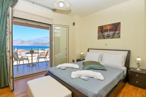 1 dormitorio con 1 cama y balcón en Sand Lily Residence, en Plakias