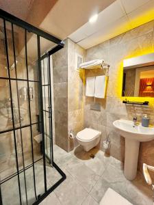a bathroom with a toilet and a sink and a shower at Naila Hotel in Istanbul