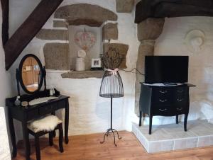 a room with a vanity and a mirror and a table at La Gerbaudiere Chambres&Table d hotes proche Mont Saint Michel cuisine maison in Notre-Dame-du-Touchet