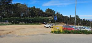 a parking lot with parked cars and a parking sign at Estudio en alquiler in Begur