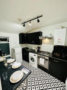 a kitchen with a table with plates on it at *Super central 20min to Big Ben* in London