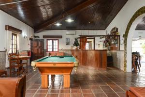 a pool table in the middle of a room at Hotel Rural A Coutada - Peniche in Atouguia da Baleia