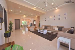 a large living room with couches and a table at EKO STAY - Octagon Farms Villa in Lonavala