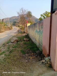 an empty road next to a wall next to a street at Prince Guest House in Panchkula