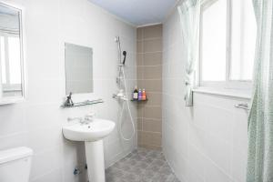 a white bathroom with a sink and a shower at Empathy Guesthouse in Daegu +78 photos