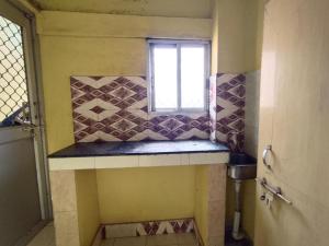 a small bathroom with a window and a sink at Shivangi Eco in Puri