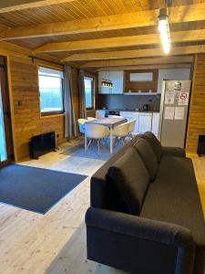 a living room with a couch and a table at Wood House Nyíregyháza in Nyíregyháza