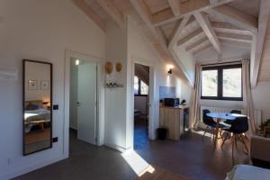 a living room with a table and a bedroom at Sandoñana Old Palace Lodge in Villafufre