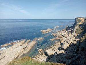 an aerial view of the ocean and a rocky coast at Piso Loredo in Loredo