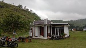 a small house with motorcycles parked in front of it at Ya Bunayya Villa in Sembalun Lawang