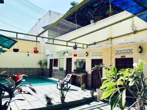 a house with a swimming pool and a patio at Hotel Ushaan Haveli in Udaipur
