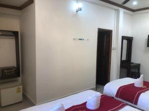 a hotel room with two beds and a mirror at Xuan Keo place house 2 in Luang Prabang