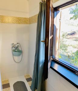a bathroom with a shower with a window at Lucky Home - Apartment Art Grožnjan in Grožnjan