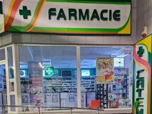 a store front with a pharmacy sign in a store at Garii Studio in Brăila
