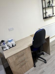 una oficina con escritorio y silla azul en Motorpoint view, en Nottingham