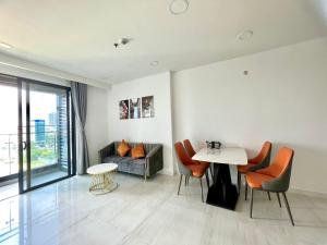 a living room with a table and a couch at Zhome-2BR apartment in Kingdom101-District 10 in Ho Chi Minh City
