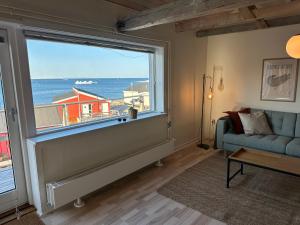 a living room with a large window and a couch at Grand seaview house Ilulissat in Ilulissat