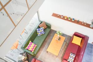 an overhead view of a living room with a table and chairs at Empathy Guesthouse in Daegu