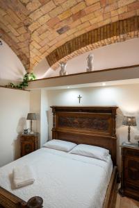 a bedroom with a large bed with a wooden headboard at DOMUS GELSOMINO in Rome