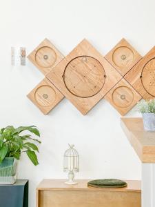 a set of four wooden plates hanging on a wall at Empathy Guesthouse in Daegu