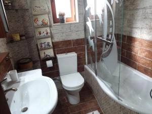 a bathroom with a toilet and a sink and a shower at Poly's House in Kavála