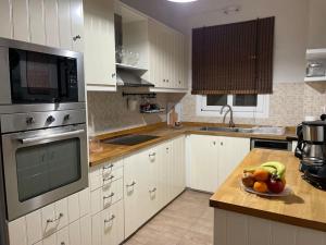 a kitchen with a bowl of fruit on a counter at Sea Breeze Holiday Home in Monemvasia