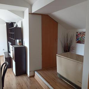 a living room with a refrigerator and a door at STAN NA DAN in Zaječar +10 photos
