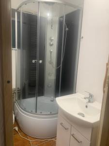 a bathroom with a shower and a sink at Central and affordable room in basement in Krakow