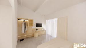 een witte kamer met een badkamer met een bed en een televisie bij ZAELIG Hotel in Knokke-Heist