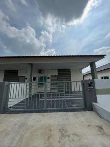 a house with a gate in front of it at Double Seven Eight Homestay SemiD at Bandar Baru Setia Awan Perdana in Sitiawan