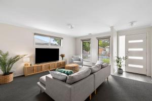 a living room with a couch and a flat screen tv at West Addis I Longer Stays Welcome in Geelong West