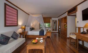 a bedroom with a bed and a living room at Governor's Residence in Yangon