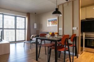 a kitchen and dining room with a table and chairs at MH Apartments Urban in Barcelona