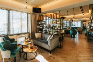 a living room with a couch and chairs and tables at Green Hotel in Inowrocław