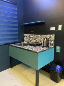 a kitchen counter with a sink in a room at Clark CU Hotel in Angeles