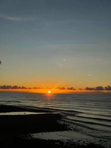 a sunset over the ocean with the sun in the sky at Lovely Bedroom in Lila, Bohol with AC and Refrigerator in Lila