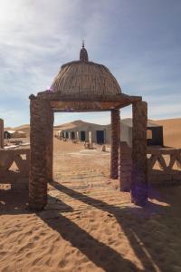 a structure in the middle of the desert at Erg Chegaga Desert Standard Camp in Mhamid