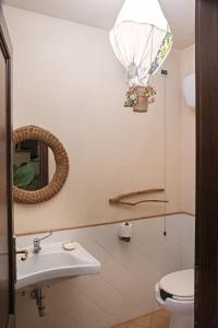 bagno con servizi igienici, lavandino e luce di Casale Pomodoro a Manziana