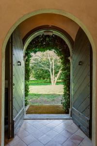 an archway leading to a door with an open yard at Casale Pomodoro in Manziana