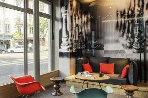 a living room with a couch and a table at ibis Paris Avenue de la Republique in Paris