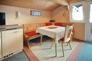 a kitchen with a table and chairs in a room at Gästehaus Bergfrieden in Bolsterlang